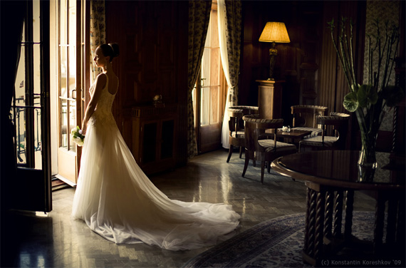 Bride facing window allowing natural light to illuminate her