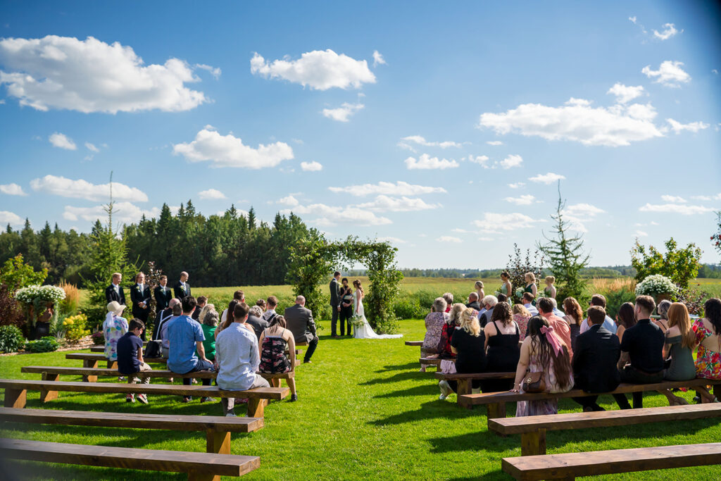 Outdoor wedding ceremony at The Black Barn Alberta with sweeping prairie backdrop – Edmonton wedding venue