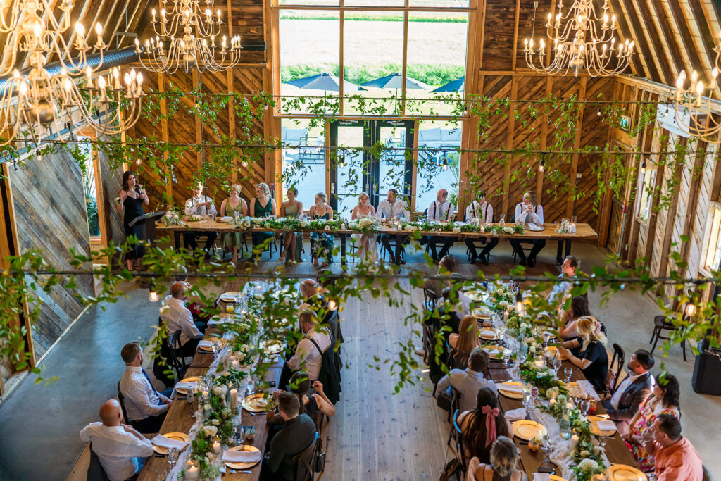 Wedding reception at The Black Barn – rustic décor, string lights, and long tables at Edmonton wedding venue